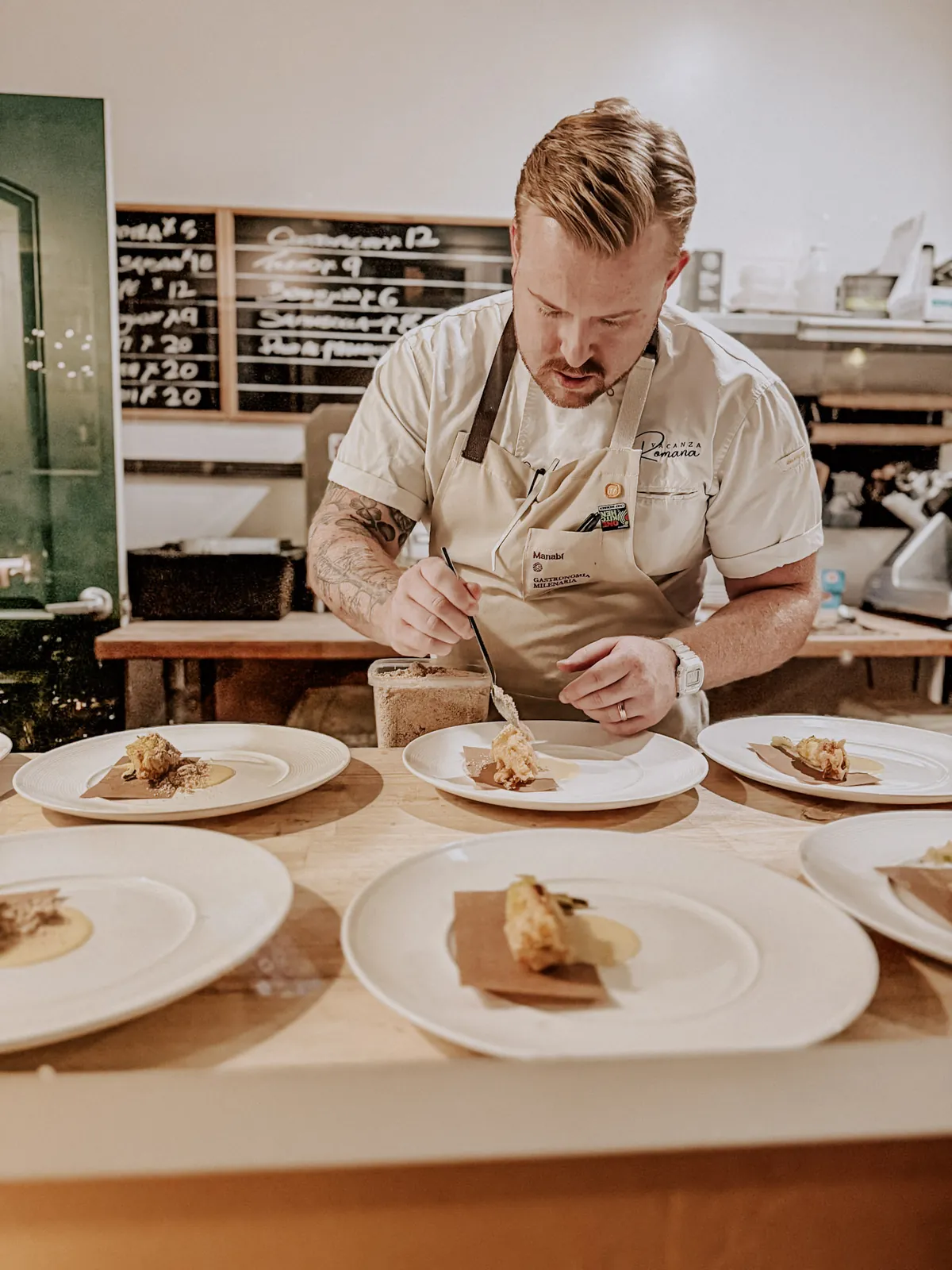 Chef Devin Dedier plating in the Vacanza Romana kitchen
