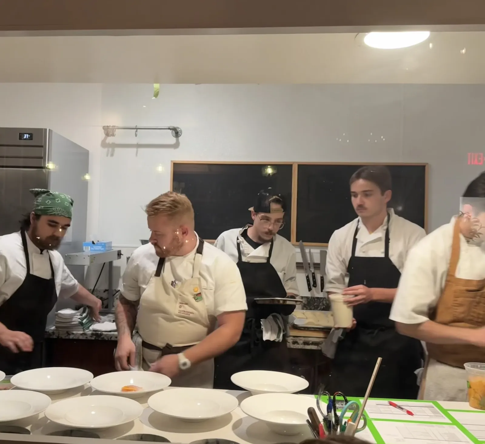 The kitchen line plating a course during dinner service at Vacanza Romana